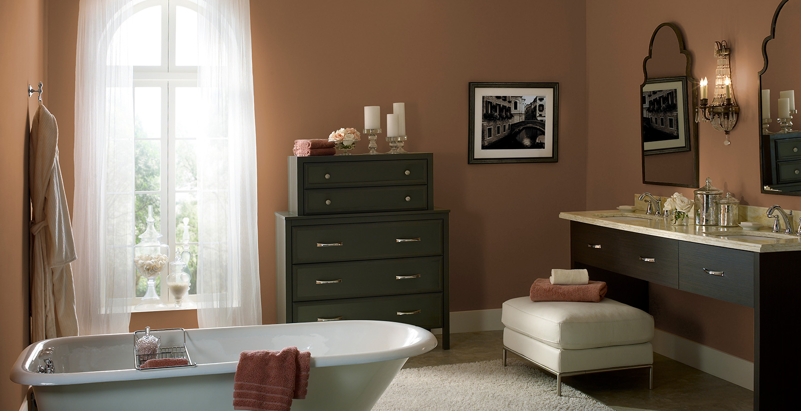 Modish themed bathroom with orange walls, white trim, and dark wooden dresser and sink.